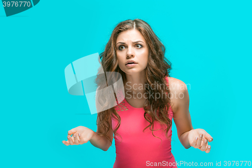 Image of Portrait of young woman with shocked facial expression