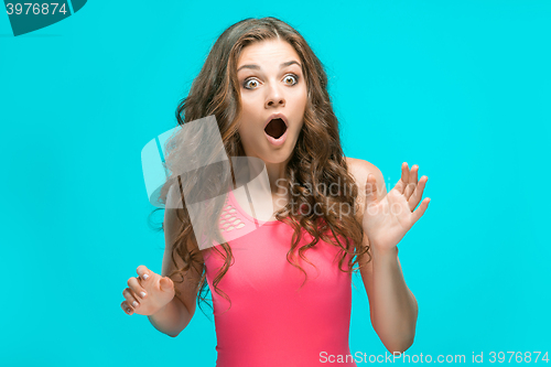 Image of Portrait of young woman with shocked facial expression