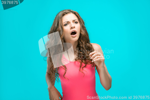 Image of Portrait of young woman with shocked facial expression