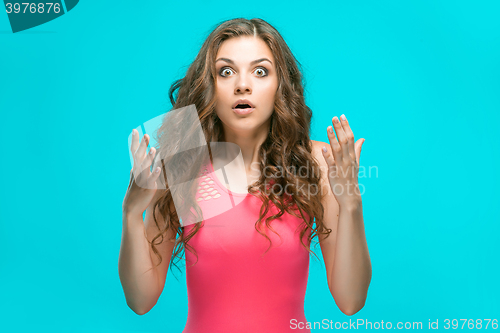 Image of Portrait of young woman with shocked facial expression