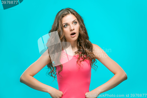 Image of Portrait of young woman with shocked facial expression