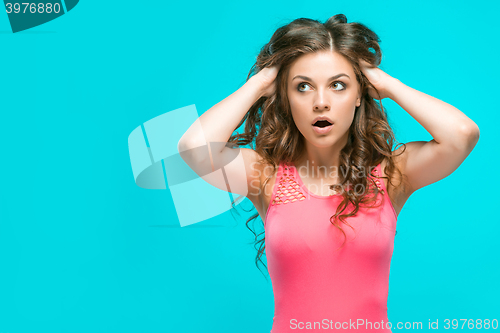 Image of Portrait of young woman with shocked facial expression