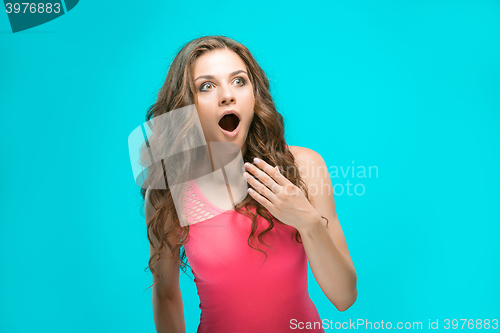 Image of Portrait of young woman with shocked facial expression