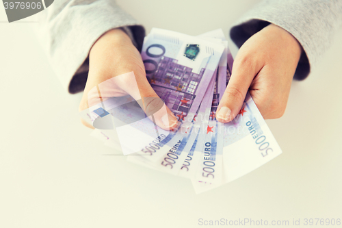 Image of close up of woman hands counting euro money