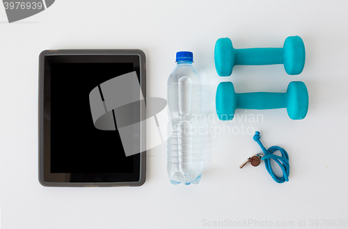 Image of tablet pc, dumbbells, whistle and water bottle