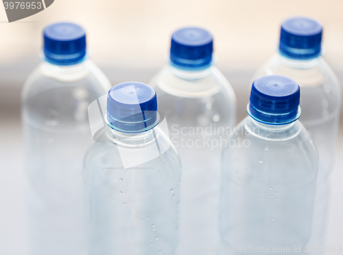 Image of close up of bottles with drinking water on table