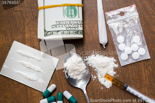 Image of close up of drugs, money, spoon and syringe