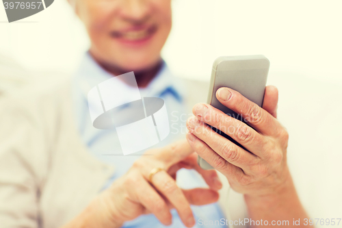 Image of close up of senior woman with smartphone texting