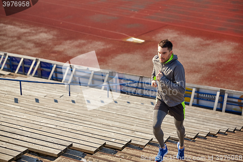 Image of young man running upstairs on stadium