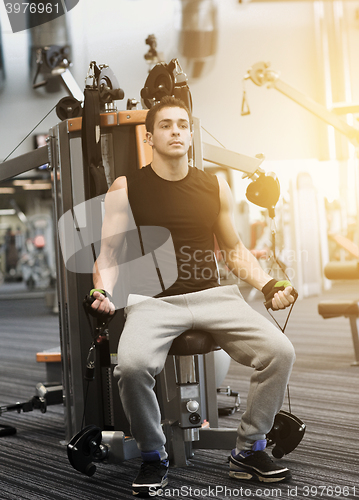 Image of man exercising on gym machine
