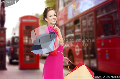 Image of woman with shopping bags over london city street