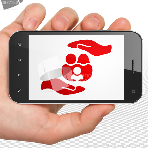 Image of Insurance concept: Hand Holding Smartphone with Family And Palm on display