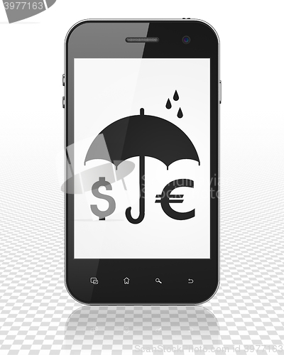 Image of Safety concept: Smartphone with Money And Umbrella on display