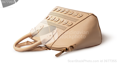 Image of Elegant leather beige handbag lying