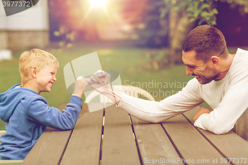 Image of happy family in front of house outdoors