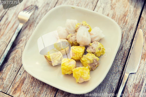 Image of plate of spring rolls with rice on table