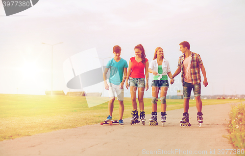 Image of group of smiling teenagers with roller-skates