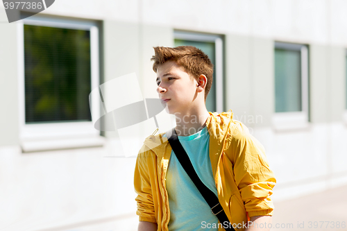 Image of teenage student boy walking outdoors