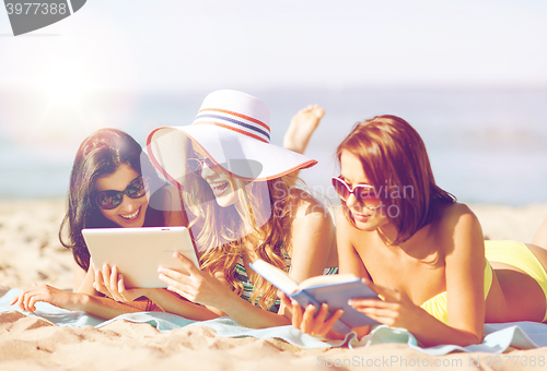 Image of girls with tablet pc on the beach