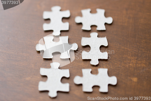Image of close up of puzzle pieces on wooden surface