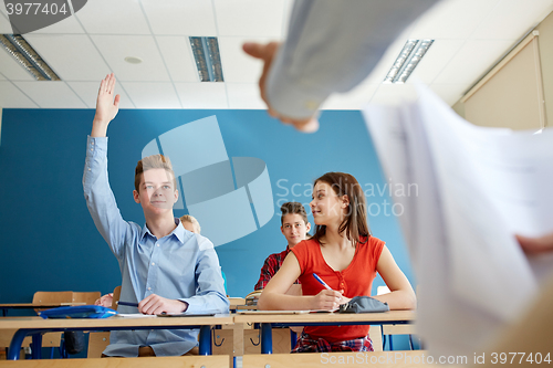 Image of group of students and teacher with papers or tests