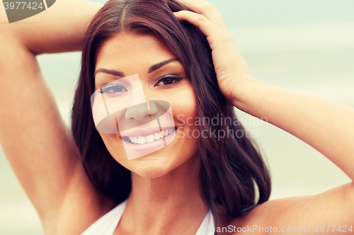 Image of happy young woman on beach