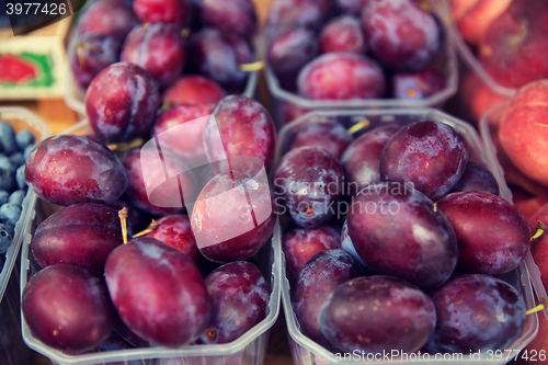 Image of close up of satsuma plums at street market