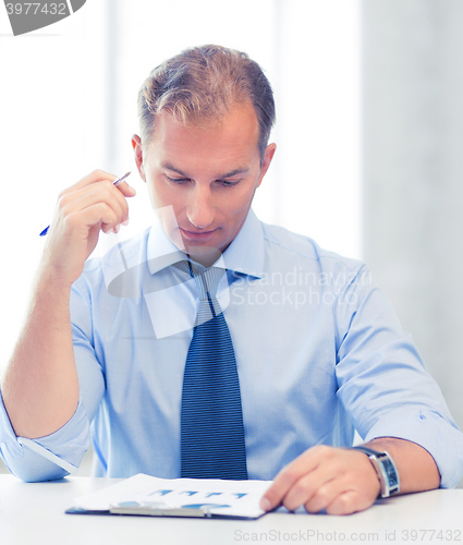 Image of businessman writing in notebook