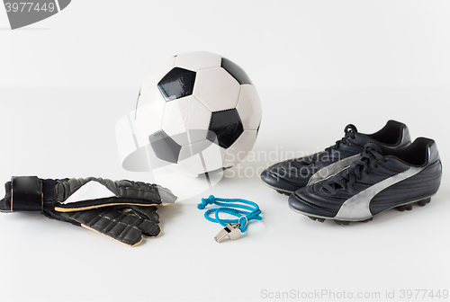 Image of close up of soccer ball, gloves, whistle and boots
