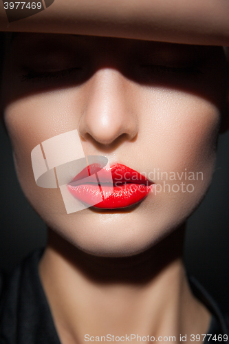 Image of Close-up of model with red lips and perfect skin