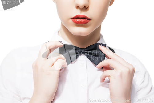 Image of Close up portrait of  young woman in white shirt and bow tie with red lipstick 