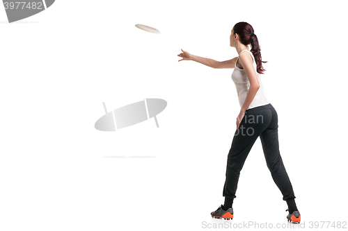 Image of young happy woman playing with flying disc