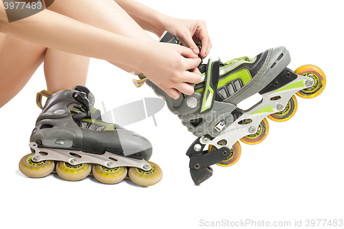 Image of Woman lacing up rollers 