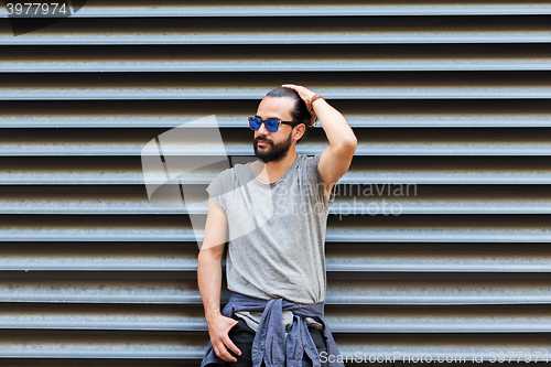 Image of happy smiling man with beard on city street