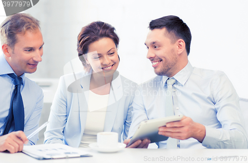 Image of business team having fun with tablet pc in office