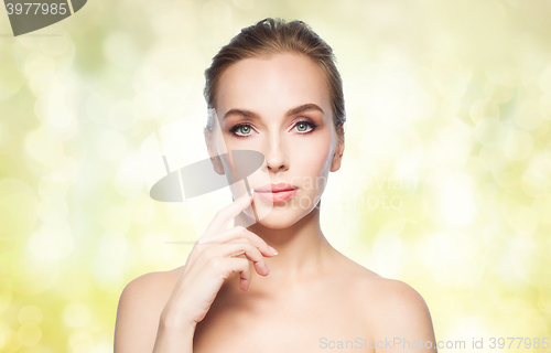 Image of beautiful young woman showing her lips