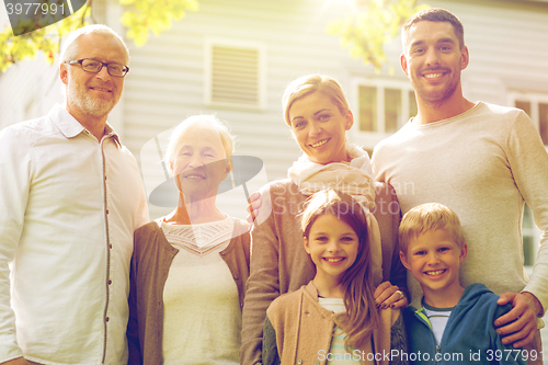 Image of happy family in front of house outdoors