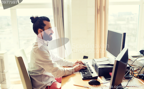 Image of happy creative male office worker with computer