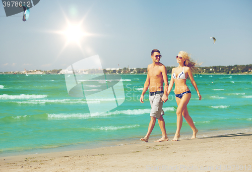 Image of couple walking on the beach