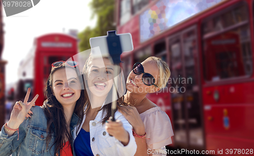 Image of group of smiling women taking selfie in london