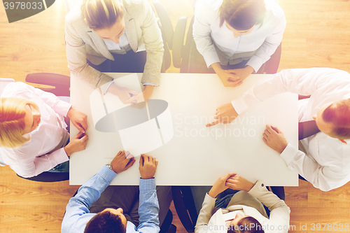 Image of close up of business team sitting at table