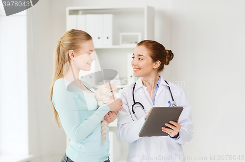 Image of happy woman with cat and doctor at vet clinic