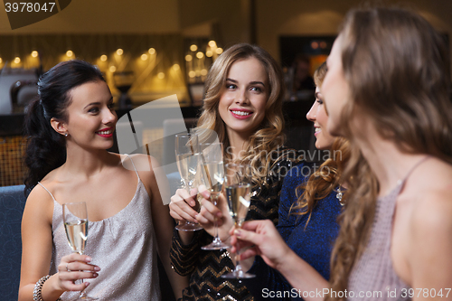 Image of happy women with champagne glasses at night club