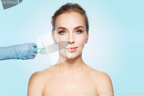 Image of woman face and hand with syringe making injection