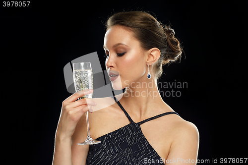 Image of young asian woman drinking champagne at party