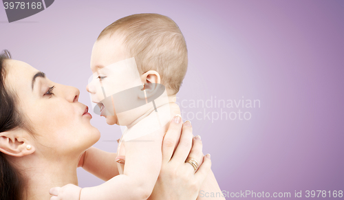 Image of happy mother kissing adorable baby