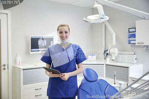 Image of happy female dentist with tablet pc at clinic