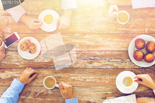 Image of close up of business team drinking coffee on lunch