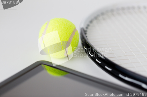 Image of close up of tennis racket with ball and tablet pc