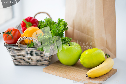 Image of basket of fresh friuts and vegetables at kitchen